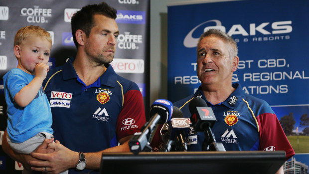 Chris Fagan and new recruit Luke Hodge  with son Leo address the media.