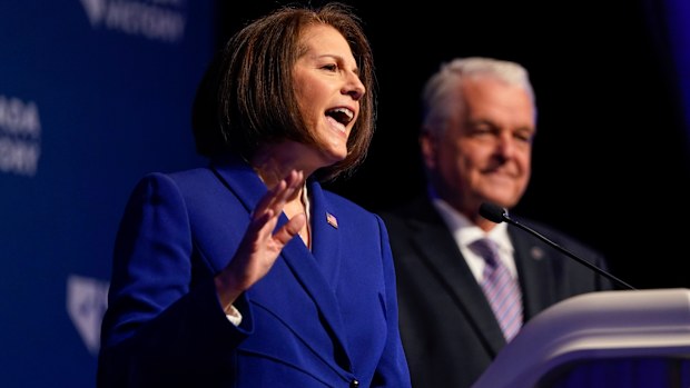 Sen. Catherine Cortez Masto, D-Nev., left, speaks alongside Nevada Gov. Steve Sisolak during an election night party hosted by the Nevada Democratic Party, Tuesday, Nov. 8, 2022, in Las Vegas. (AP Photo/Gregory Bull)