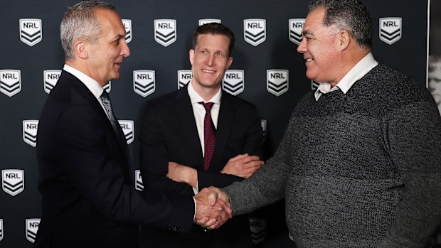 Perth Bears head coach Mal Meninga shakes hands with NRL CEO Andrew Abdo as Bears CEO Anthony De Ceglie looks on.