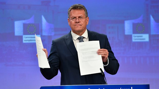 European Commissioner for Inter-institutional Relations and Foresight Maros Sefcovic holds up documents as he speaks during a media conference at EU headquarters in Brussels on Wednesday.