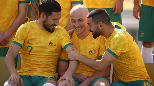 Mathew Leckie, Aaron Mooy and Aziz Behich pictured clowning around during the Socceroos' official team photo in Qatar.