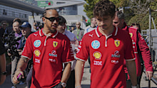Ferrari driver Lewis Hamilton of Britain, left, chats with his teammate Charles Leclerc of Monaco as they walk out from their team's hospitality suite ahead of the Chinese Formula One Grand Prix, in Shanghai, China, Friday, March 21, 2025. (AP Photo/Andy Wong)