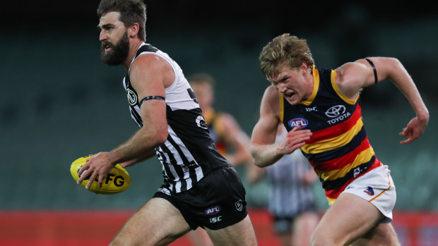 Justin Westhoff of the Power breaks away from Fischer McAsey of the Crows.