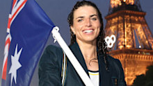 Jessica Fox, Flagbearer of Team Australia, poses with her flag on a boat along the River Seine during the opening ceremony of the Olympic Games Paris 2024.