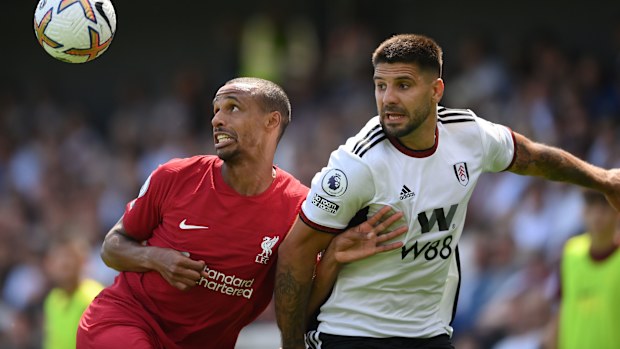 Joel Matip of Liverpool is challenged by Aleksandar Mitrovic of Fulham. 