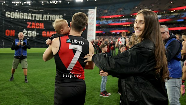 Zach Merrett of the Bombers is congratulated on his 250th game.
