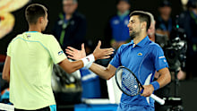 MELBOURNE, AUSTRALIA - JANUARY 17: Novak Djokovic of Serbia embraces Alexei Popyrin of Australia after winning his round two singles match during the 2024 Australian Open at Melbourne Park on January 17, 2024 in Melbourne, Australia. (Photo by Darrian Traynor/Getty Images)