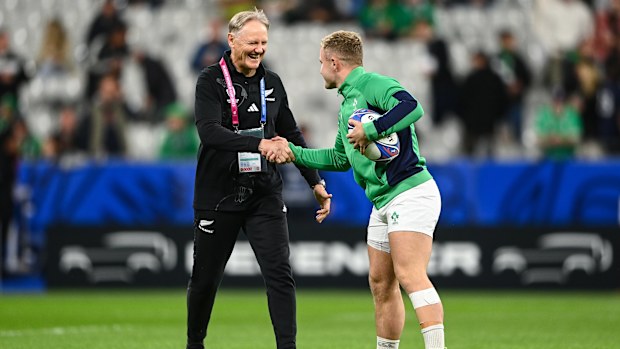 New Zealand assistant coach Joe Schmidt shakes hands with Ireland's Craig Casey.