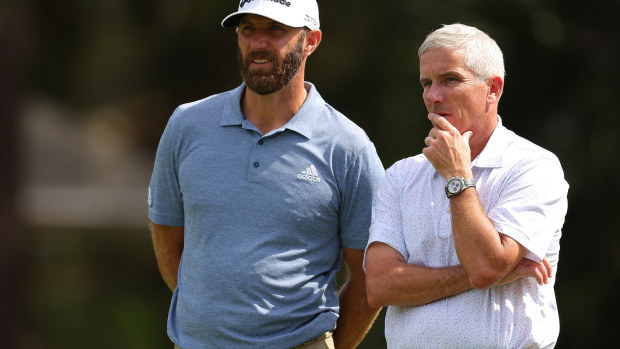 Jay Monahan converses with Dustin Johnson.