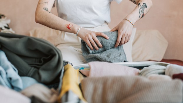Stock image of a woman folding laundry.