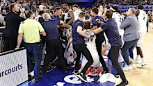 A fight breaks out on the Adelaide 36ers bench as member of the crowd clash with players.