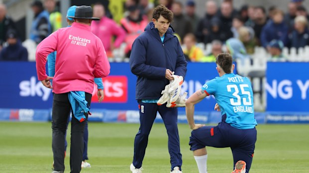 Matthew Potts of England changes one of his shoes.