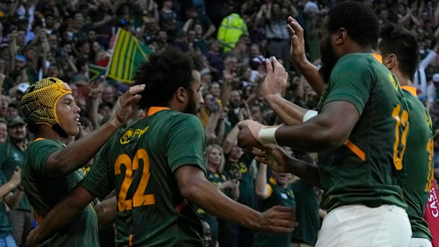 South Africa's Kurt-Lee Arendse celebrates with teammates after scoring a try.