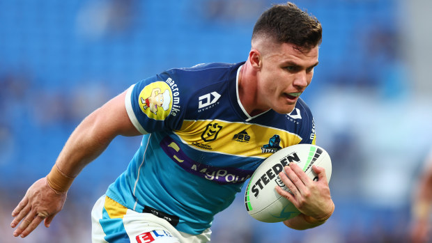 Beau Fermor of the Titans makes a break to score a try during the round 24 NRL match between the Gold Coast Titans and the Newcastle Knights at Cbus Super Stadium, on August 28, 2022, in Gold Coast, Australia. (Photo by Chris Hyde/Getty Images)