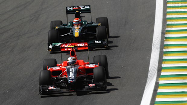 A Virgin Marussia and a Lotus during practice the 2010 Brazilian Grand Prix weekend.