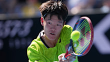 Michael Zheng of the US plays a backhand return to compatriot Sebastian Korda.