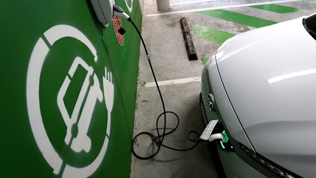 A Hyundai Kona Electric charges at a EV charge station