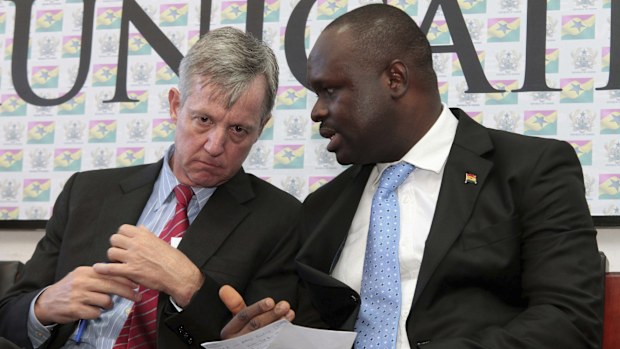 FILE - Edward Omane Boamah, Ghana's defense minister who was killed Wednesday in a helicopter crash along with several other top officials, is pictured on the right on Sept. 30, 2014 when he was information minister and talking with U.N. official Anthony Banbury at a news conference in Accra, Ghana. (AP Photo/Christian Thompson, File)