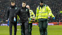 Hibernian's Martin Boyle is stretchered off after a head clash.
