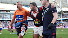 Brandon Smith limps off the field with a knee injury. 
