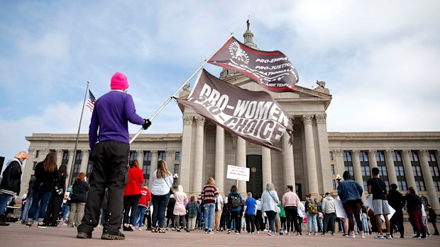 A person holds a pro-choice for women flag at a Bans Off Oklahoma Rally. 