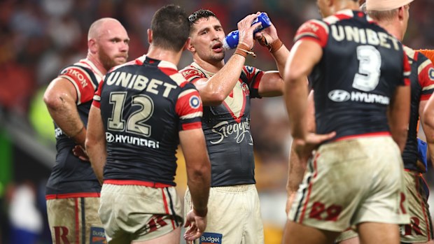 Roosters players look on after a Cowboys try during Magic Round.