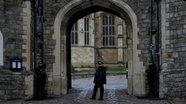 Police guard the Henry VIII gate at Windsor Castle at Windsor, England on Christmas Day, Saturday, Dec. 25, 2021. Britain's Queen Elizabeth II has stayed at Windsor Castle instead of spending Christmas at her Sandringham estate due to the ongoing COVID-19 pandemic. (AP Photo/Alastair Grant)