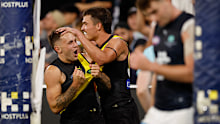 Rhyan Mansell of the Tigers grabs his jumper as he celebrates a goal.