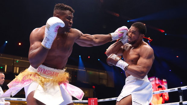 Francis Ngannou punches Anthony Joshua during the Heavyweight fight between Anthony Joshua and Francis Ngannou on the Knockout Chaos boxing card at the Kingdom Arena on March 08, 2024 in Riyadh, Saudi Arabia. (Photo by Richard Pelham/Getty Images)