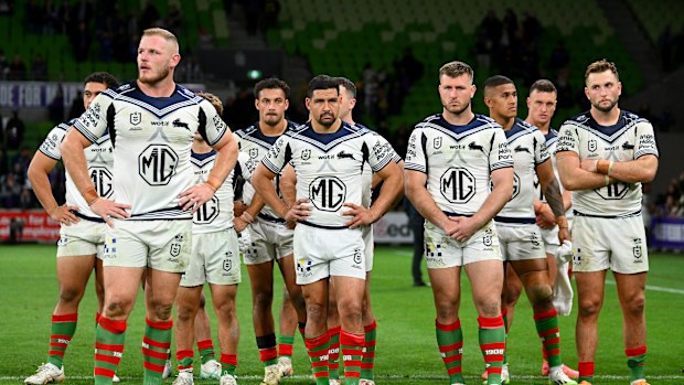 The Rabbitohs looking dejected during post-game formalities after the Anzac Day clash against the Storm.