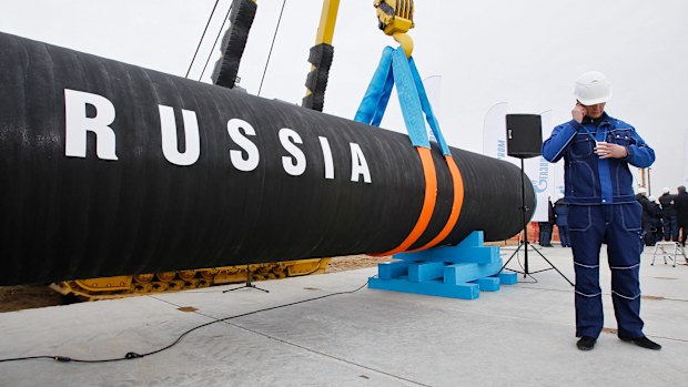 FILE - A Russian construction worker speaks on a mobile phone during a ceremony marking the start of Nord Stream pipeline construction in Portovaya Bay some 170 km north-west from St. Petersburg, Russia on April 9, 2010. Russian energy giant Gazprom said Friday, Sept. 2, 2022 that it can't resume the supply of natural gas through a key pipeline to Germany for now because of what it said was a need for urgent maintenance work, just hours before it was due to recommence deliveries. 