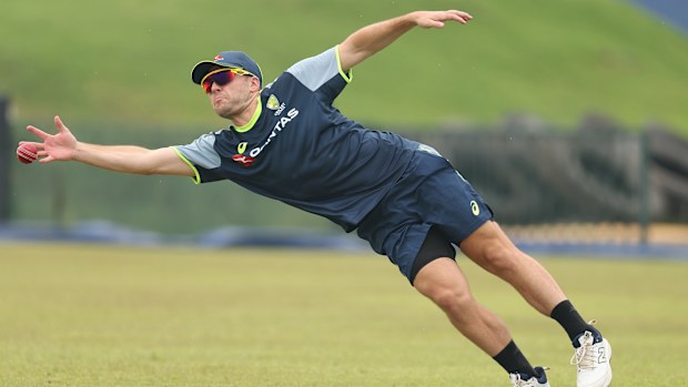 Josh Inglis dives for a catch during a training session in Galle.
