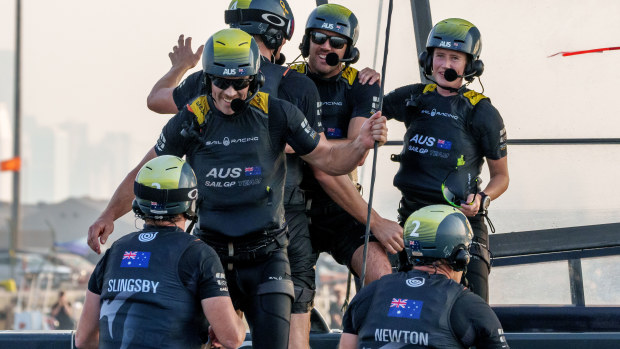 Australia's SailGP team celebrates on board their F50 after their dramatic win in the final match race in Dubai.