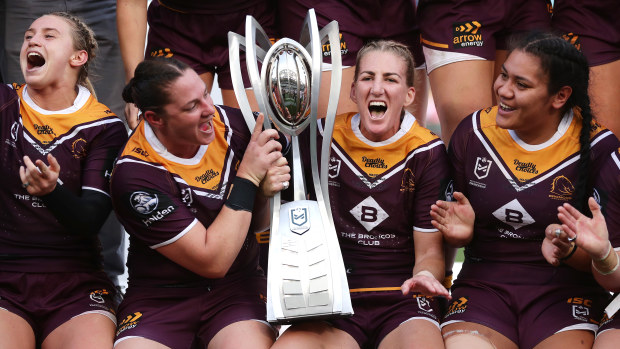Broncos captain Ali Brigginshaw celebrates with teammates and the trophy.