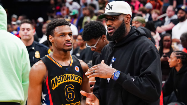 HOUSTON, TEXAS - MARCH 28: Bronny James #6 of the West team talks to Lebron James of the Los Angeles Lakers after the 2023 McDonald's High School Boys All-American Game at Toyota Center on March 28, 2023 in Houston, Texas. (Photo by Alex Bierens de Haan/Getty Images)