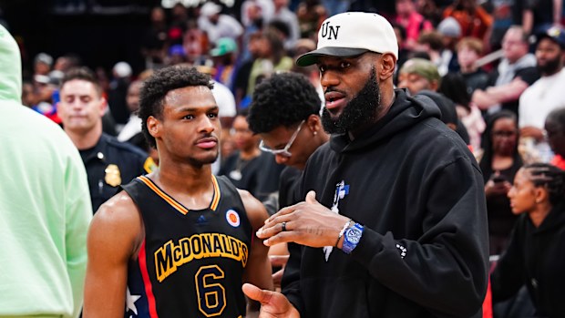 HOUSTON, TEXAS - MARCH 28: Bronny James #6 of the West team talks to Lebron James of the Los Angeles Lakers after the 2023 McDonald's High School Boys All-American Game at Toyota Center on March 28, 2023 in Houston, Texas. (Photo by Alex Bierens de Haan/Getty Images)