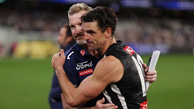 Geelong assistant coach Nathan Buckley and Collingwood's Scott Pendlebury.