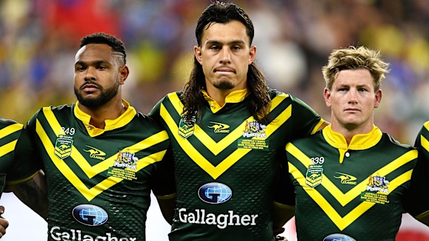Hamiso Tabuai-Fidow, Tino Fa'asuamaleaui and harry Grant line up for the national anthems during the Pacific Championship match between Australia Kangaroos and Samoa at Queensland Country Bank Stadium on October 14, 2023 in Townsville, Australia. (Photo by Ian Hitchcock/Getty Images)
