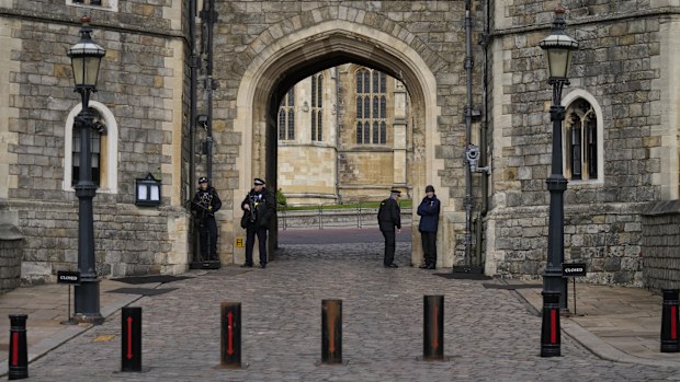Police guard the Henry VIII gate to Windsor Castle in Windsor, England, Wednesday, Feb. 16, 2022. 