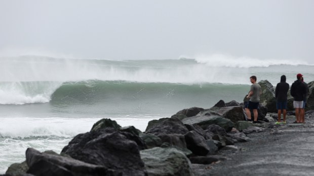 GOLD COAST, AUSTRALIA - MARCH 05: People watch the waves at Kirra Beach on March 05, 2025 in Gold Coast, Australia. Tropical Cyclone Alfred is expected to make landfall in southeast Queensland as a Category 2 storm, marking the first time a cyclone has directly hit the region in over 50 years. The storm is forecast to bring damaging winds, heavy rainfall, and potential storm surges, prompting authorities to urge residents to prepare for significant impacts, including flooding and power outages. 