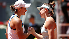 Simona Halep of Romania is congratulated by Ash Barty of Australia after her win in the quarter finals of the 2019 Madrid Open.