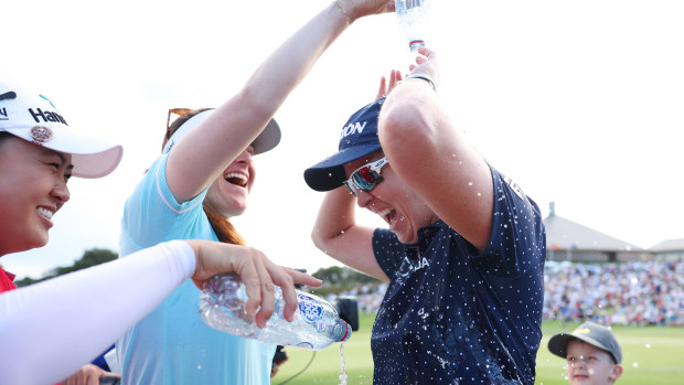 Ashleigh Buhai of South Africa is showered by Minjee Lee and Hannah Green of Australia.