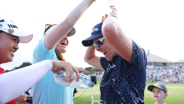 Ashleigh Buhai of South Africa is showered by Minjee Lee and Hannah Green of Australia.