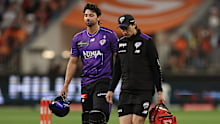 Tim David leaves the field injured