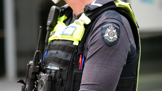 Members of Victoria Police attend a protest in Melbourne. Generic police officers uniform badge logo. Photo by Paul Rovere
