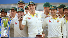 Australian captain Pat Cummins celebrates by lifting the Ashes Urn after successfully retaining the series in 2023.