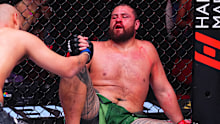 Tai Tuivasa and Tallison Teixeira embrace after their heavyweight fight.