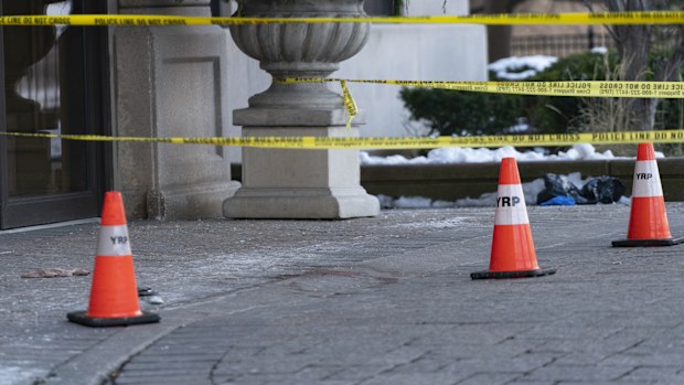 Police cones and tape are seen outside of a condominium building the day after a shooting in Vaughan, Ontario.