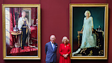 King Charles III and Queen Camilla pose with their official Coronation State Portraits during a visit to The National Gallery on May 06, 2025 in London
