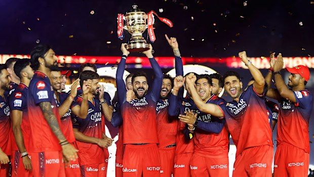 Virat Kohli of Royal Challengers Bengaluru lifts the IPL trophy alongside teammates following the team's victory in the 2025 IPL Final match between Royal Challengers Bengaluru and Punjab Kings at Narendra Modi Stadium on June 03, 2025, in Ahmedabad, India. (Photo by Pankaj Nangia/Getty Images)